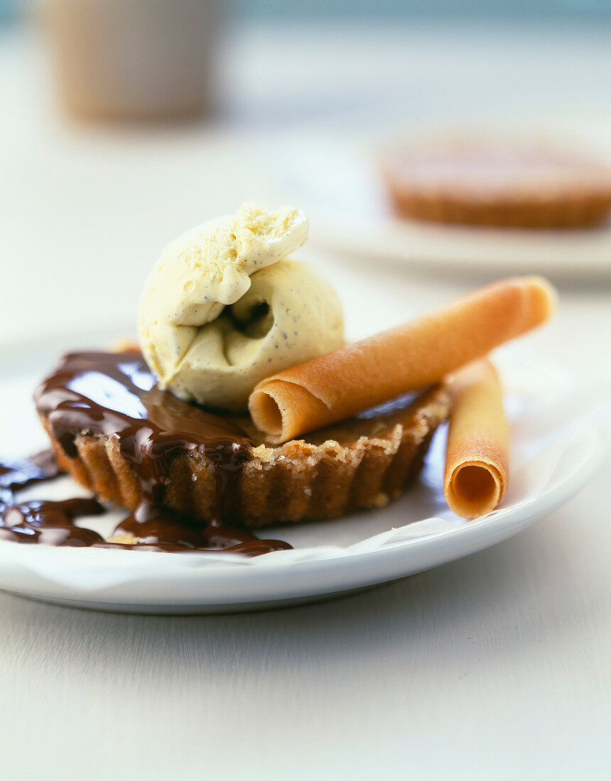 Chestnut tartlet with chocolate sauce and vanilla ice cream