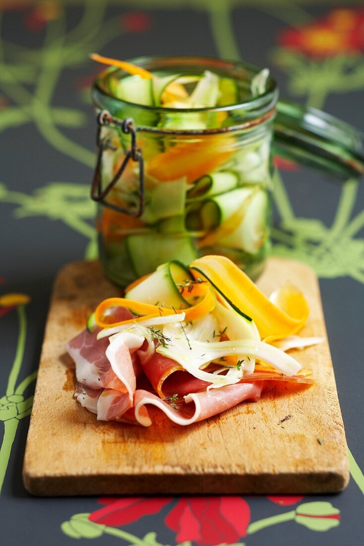 Sliced raw ham with marinated vegetables