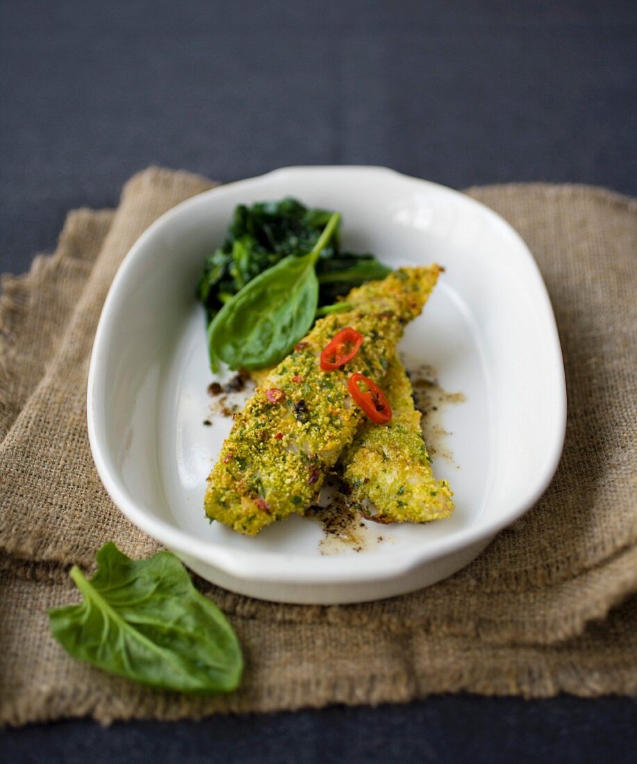 Fish fillets coated with breadcrumbs and hot red pepper