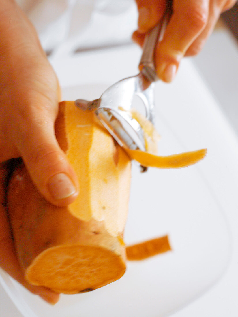 Peeling a sweet potato