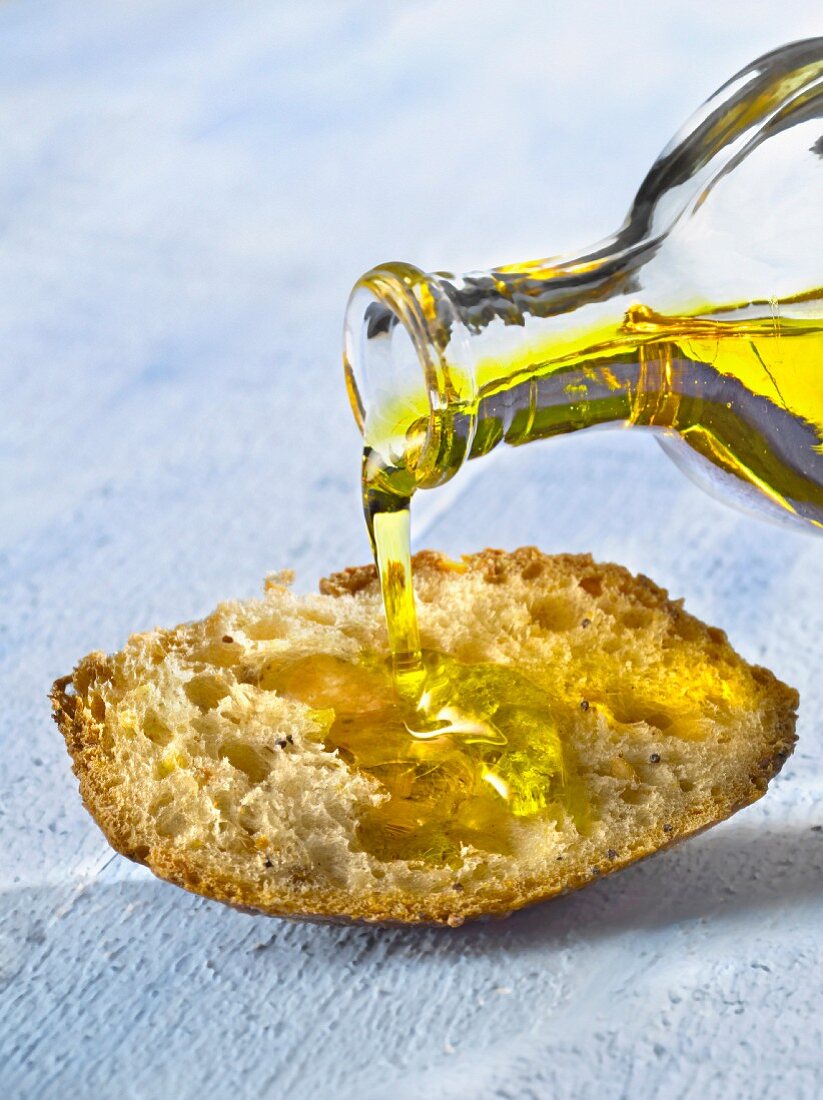 Pouring oil onto a piece of bread