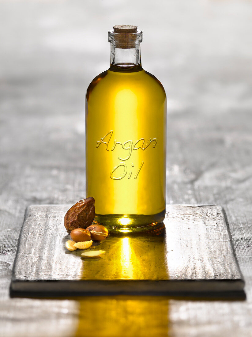 Bottle of argan oil and argan nuts