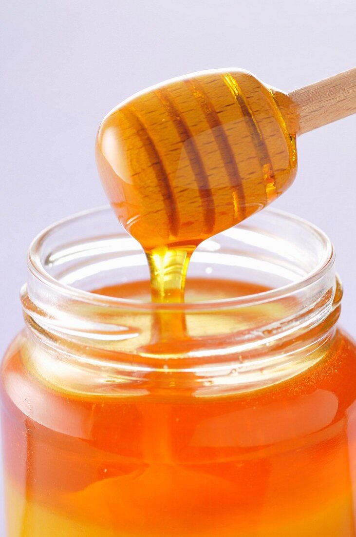 Honey spoon and jar of honey