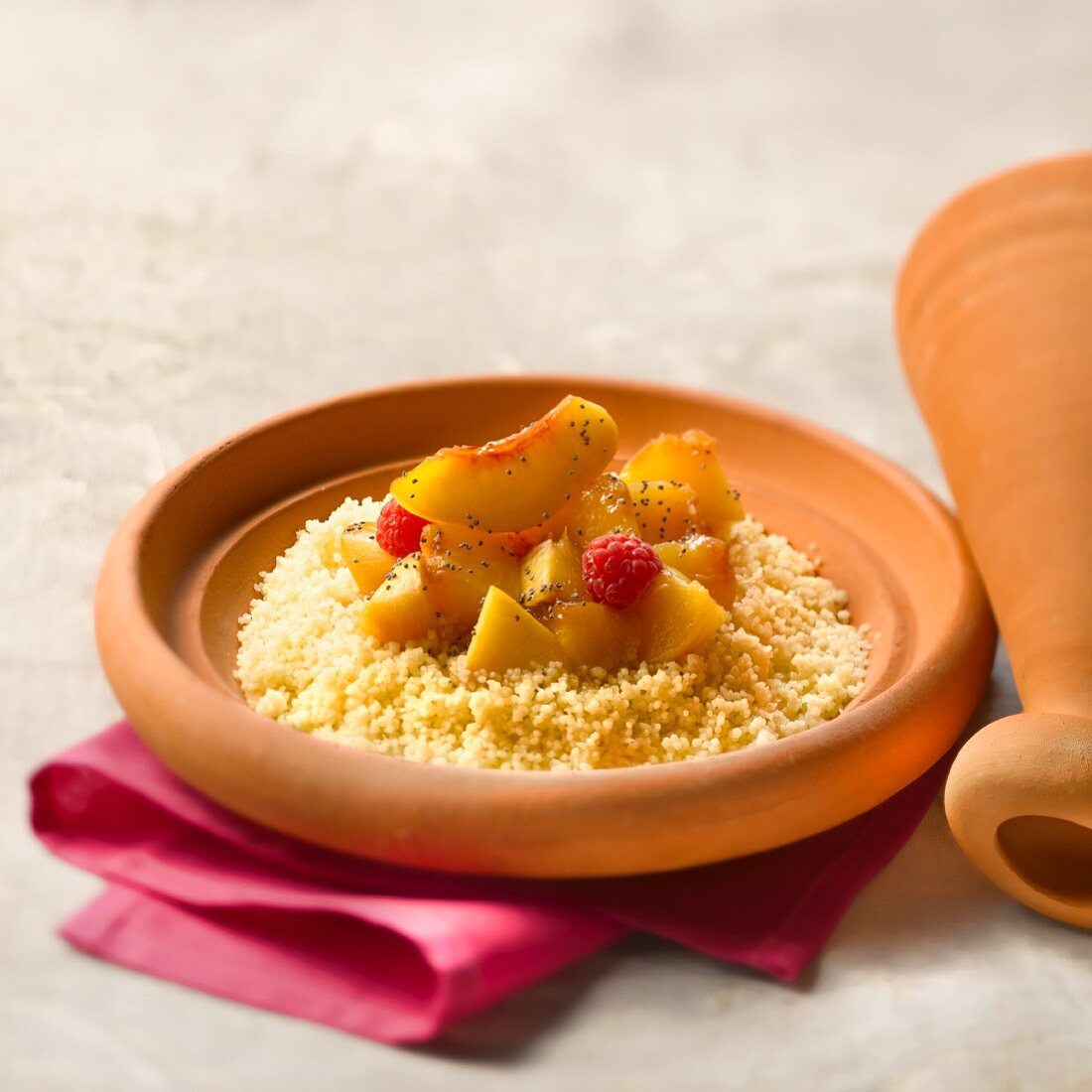 Peach and raspberry Tajine with jasmin-flavored semolina