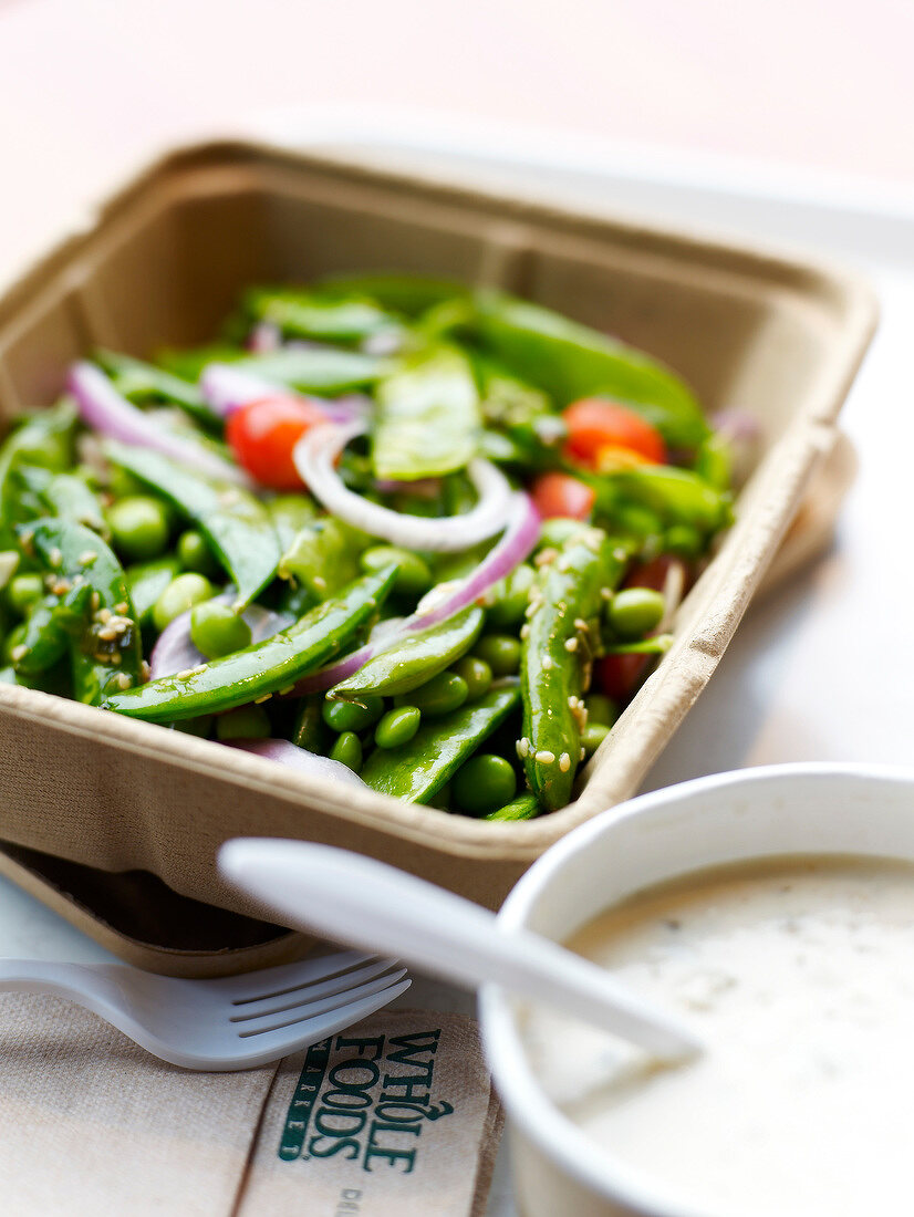 Take-away punnet of cooked green vegetables from the Whole Foods Market