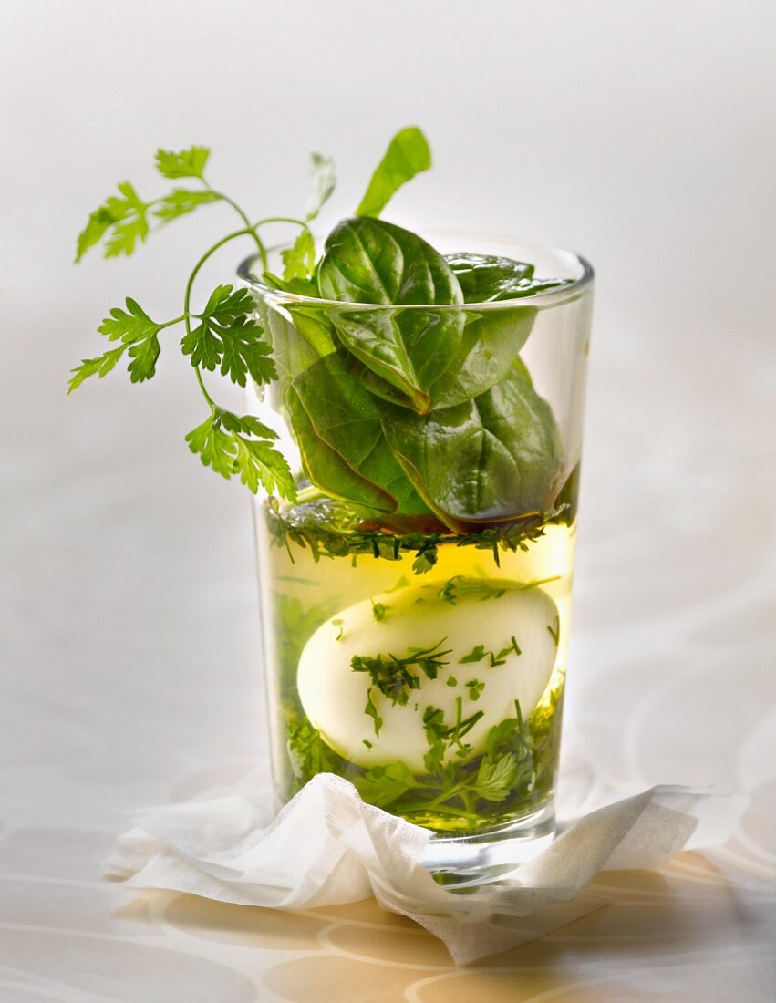 Quail's egg in aspic with herbs and spinach shoots with balsamic vinegar Verrine