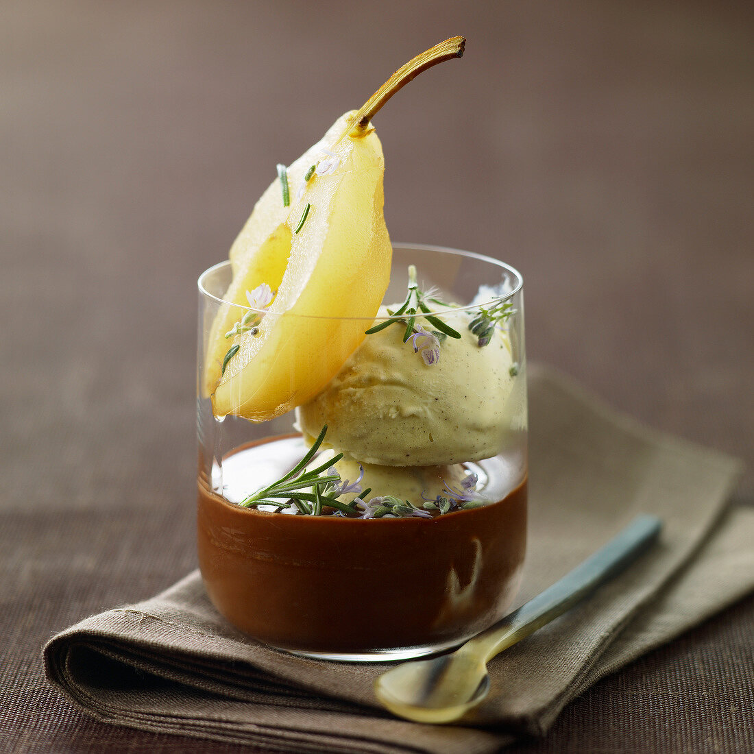 Pear stewed in a tea infusion with chocolate sauce and vanilla ice cream