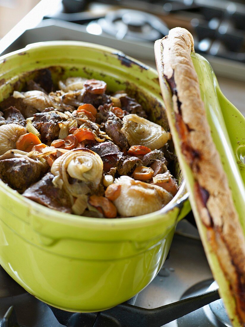 Beef ragout in a braising pot with a bread lid