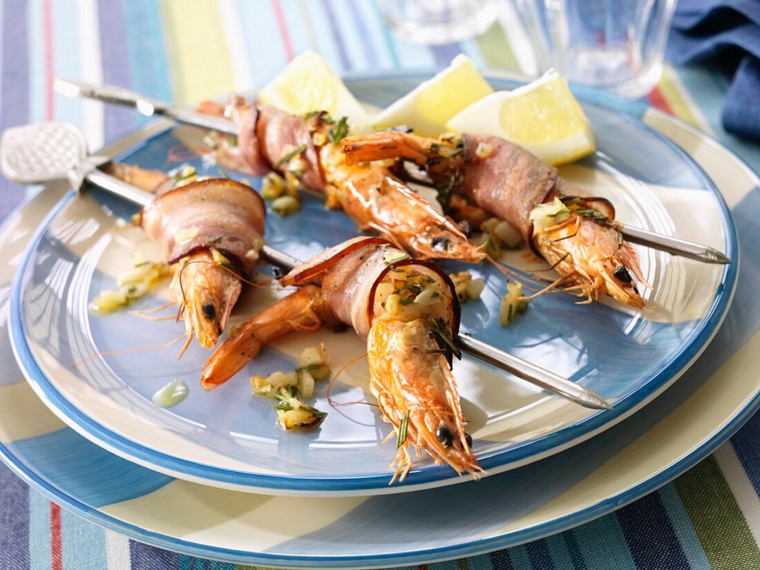 Gambas wrapped in bacon on skewers