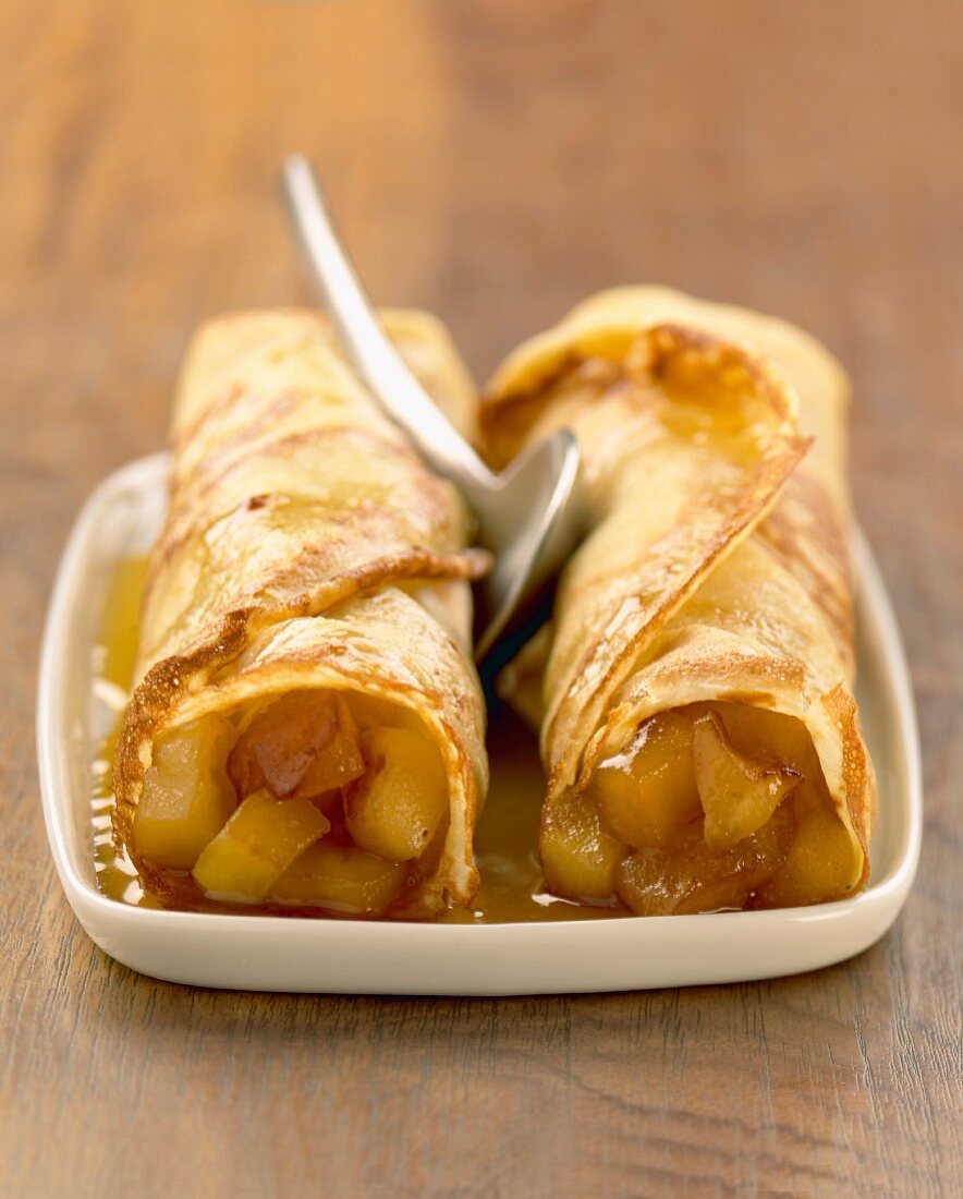 Rolled pancakes with stewed apple filling