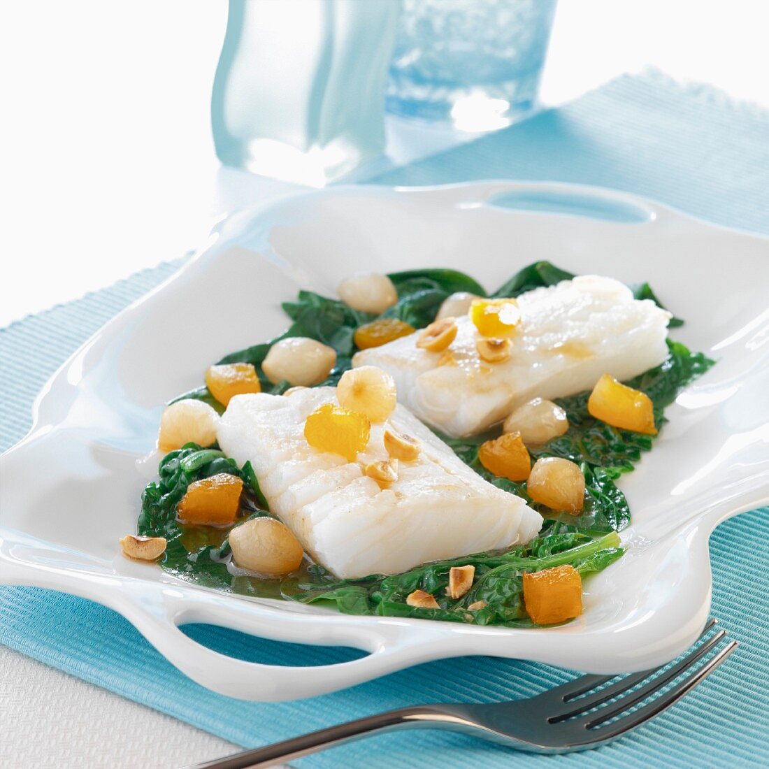 Thick pieces of cod with spinach,small onions and peanuts