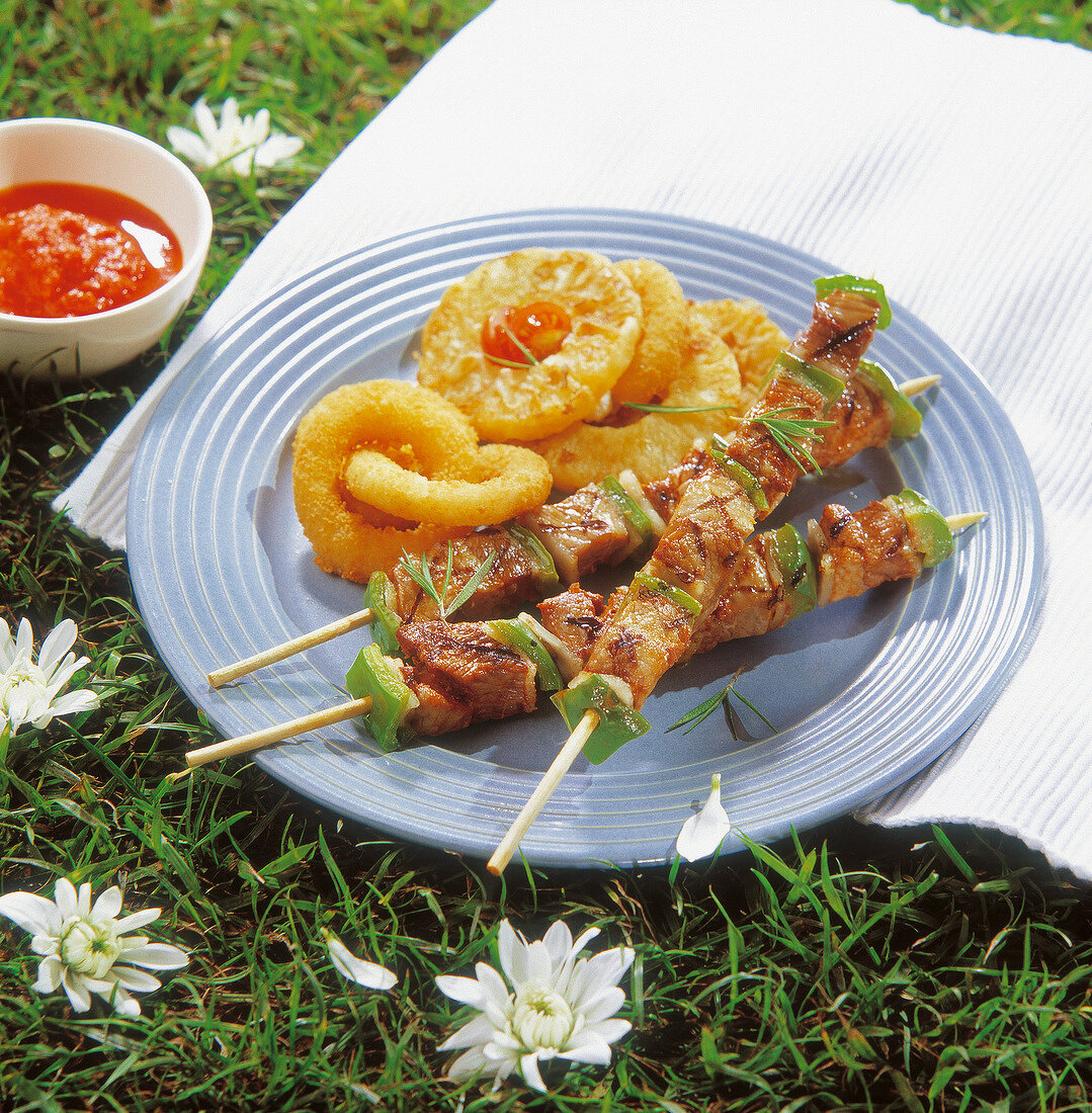 Grilled pork brochettes,fried calamaries and pineapple rings