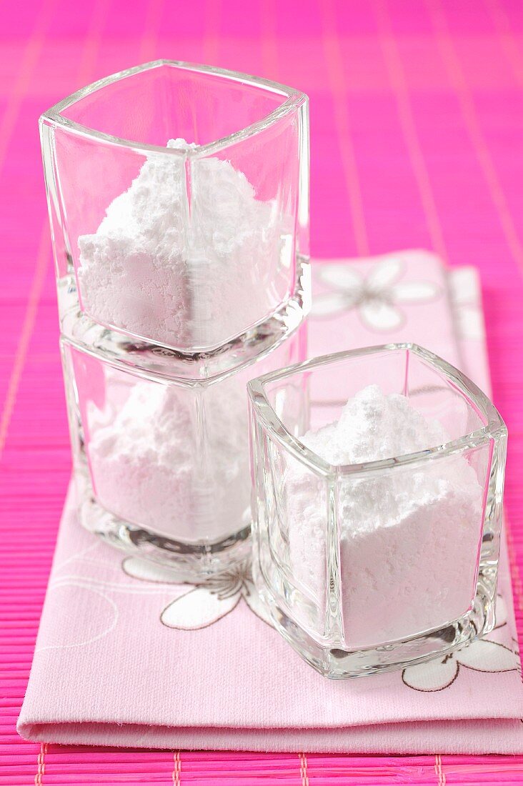 Small glass pots of icing sugar