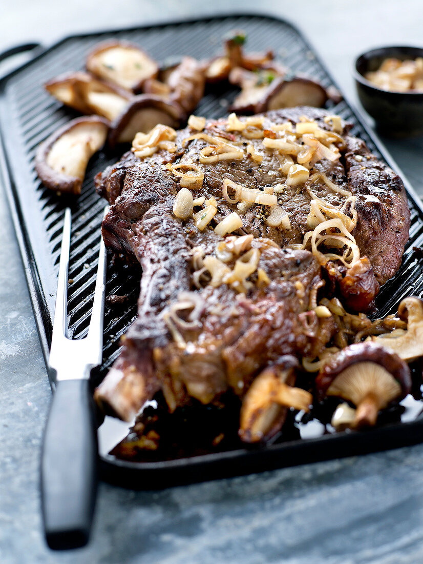 Beef chop grilled with shallots and mushrooms