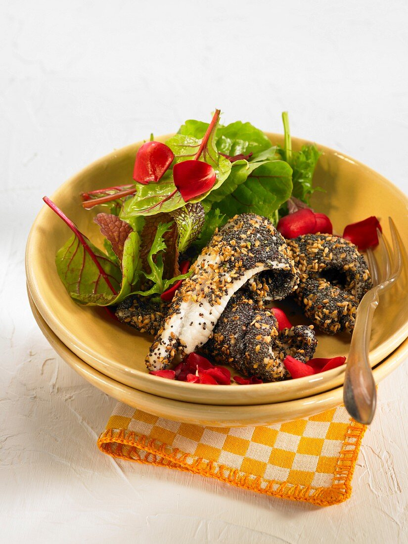 Sole fillets coated in sesame and poppyseeds, beetroot shoot and poppy salad