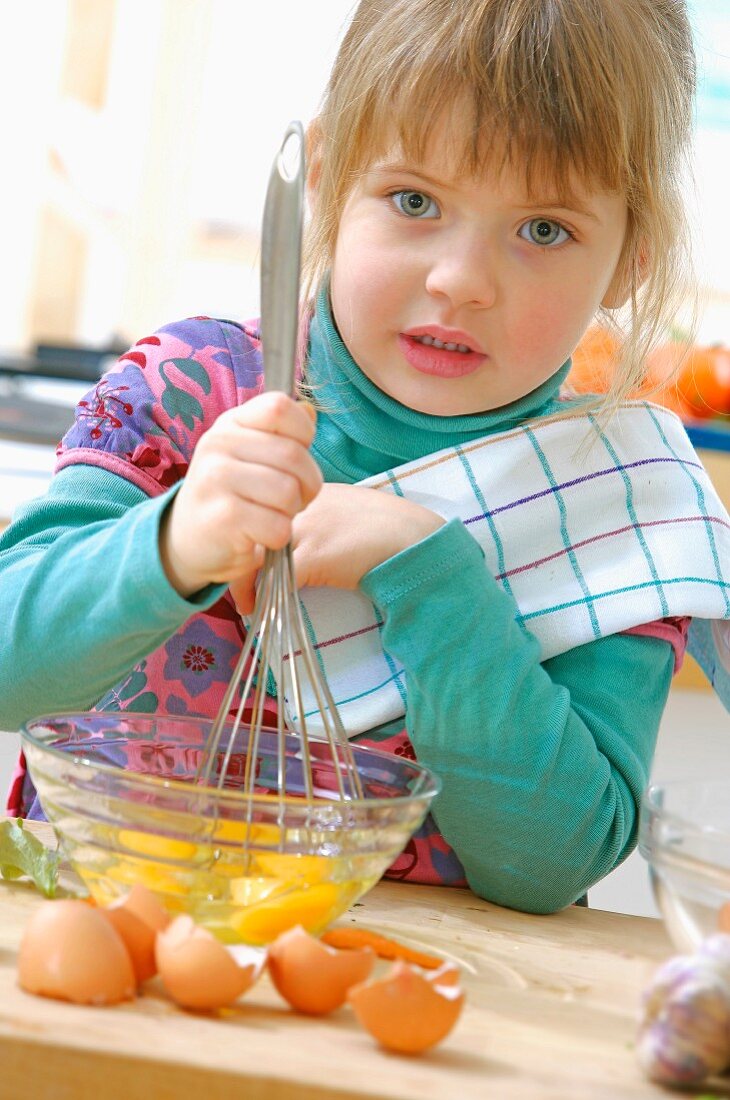 Young girl beating eggs