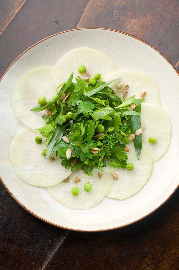 Celeriac carpaccio with herbs and peas