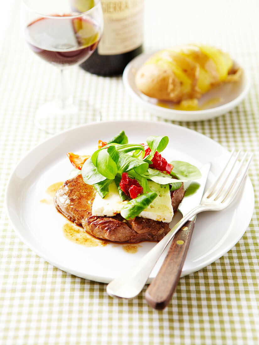 Steak topped with cheese,lamb's lettuce and sun-dried tomatoes ,balsamic sauce