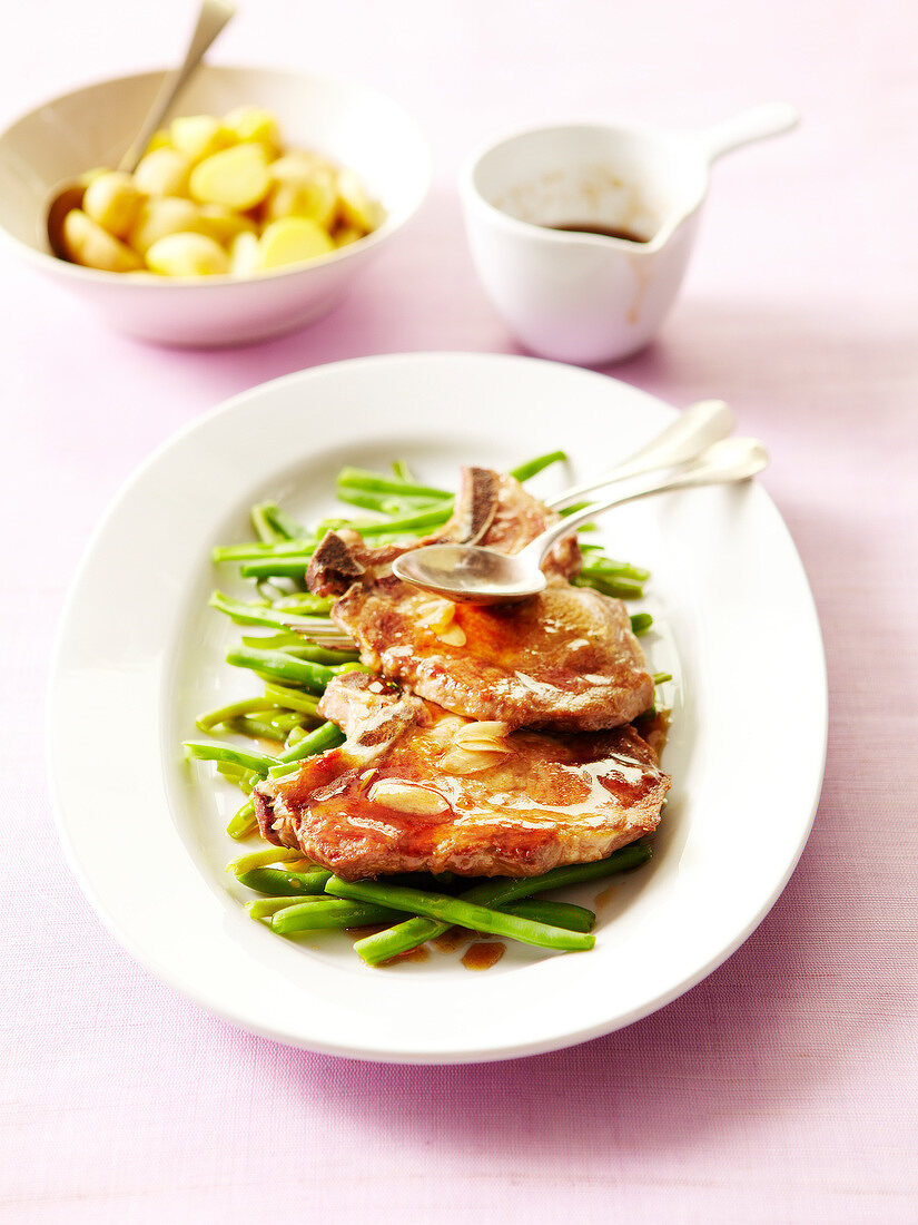 Pork chops with maple syrup and garlic sauce,steam-cooked green beans