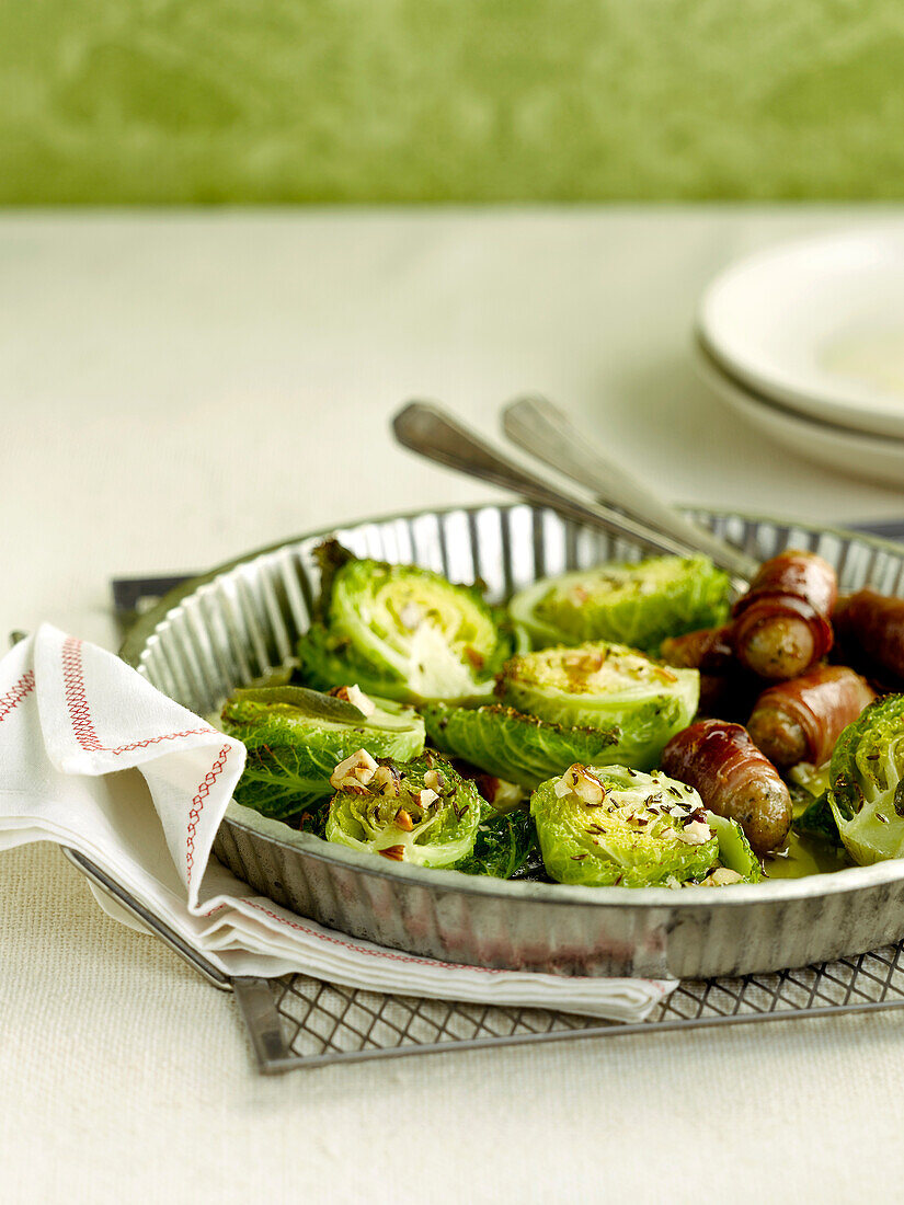 Mini cabbages with sage butter,walnuts,cumin seeds and mini sausages rolled in bacon