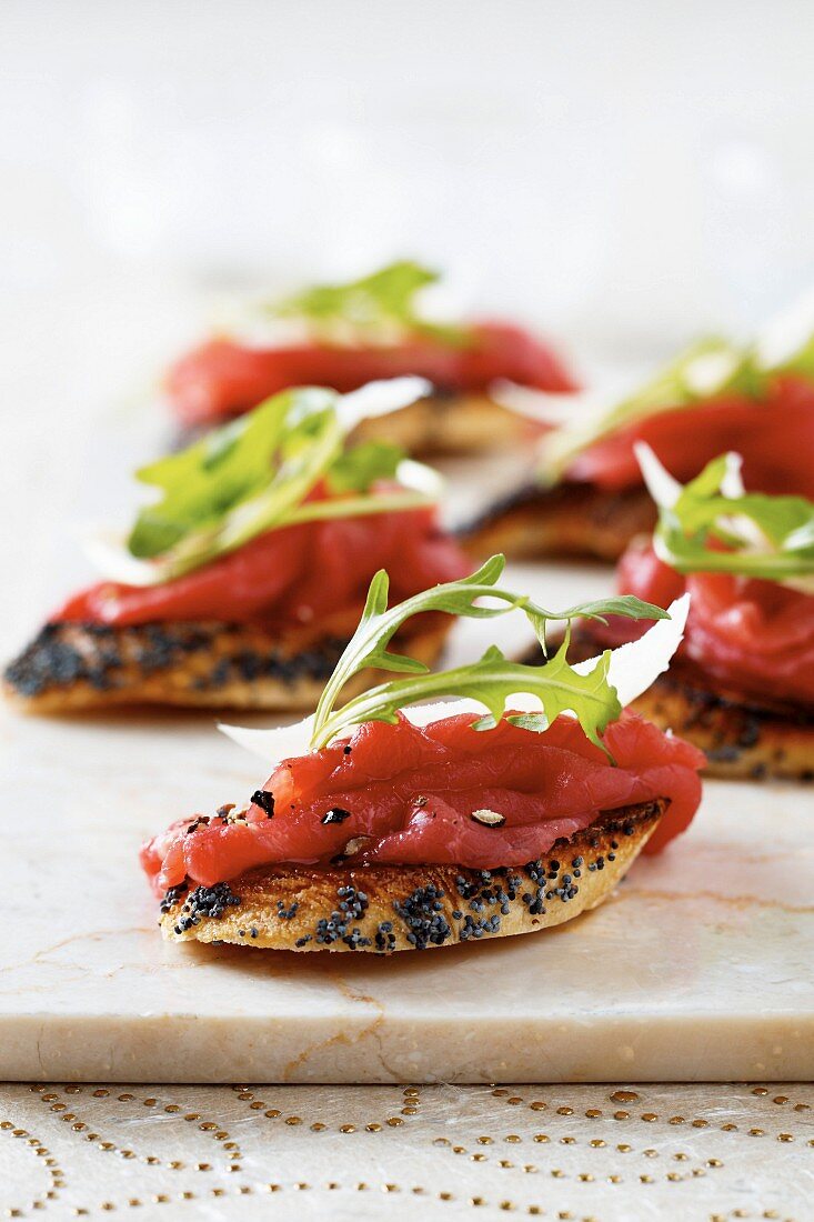 Beef carpaccio, rocket and parmesan canapés