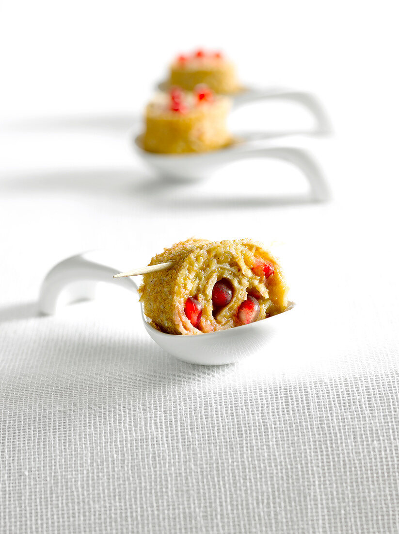 Eggplant caviar and pomegranate rolled pancake appetizer