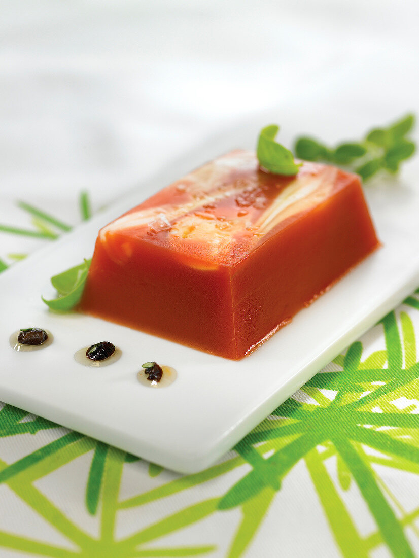 Jellied tomato terrine with black olive dressing