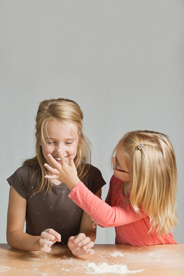 Young girls having fun making pastries