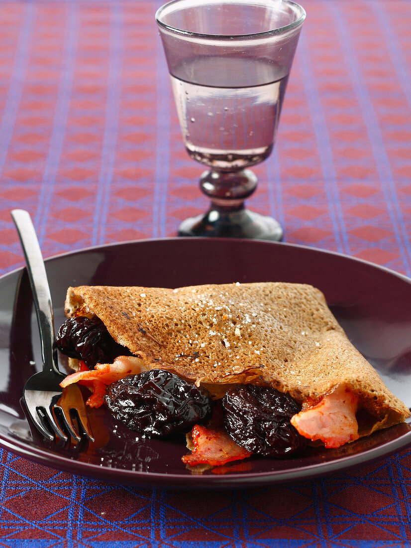 Buckwheat pancake with prunes and bacon