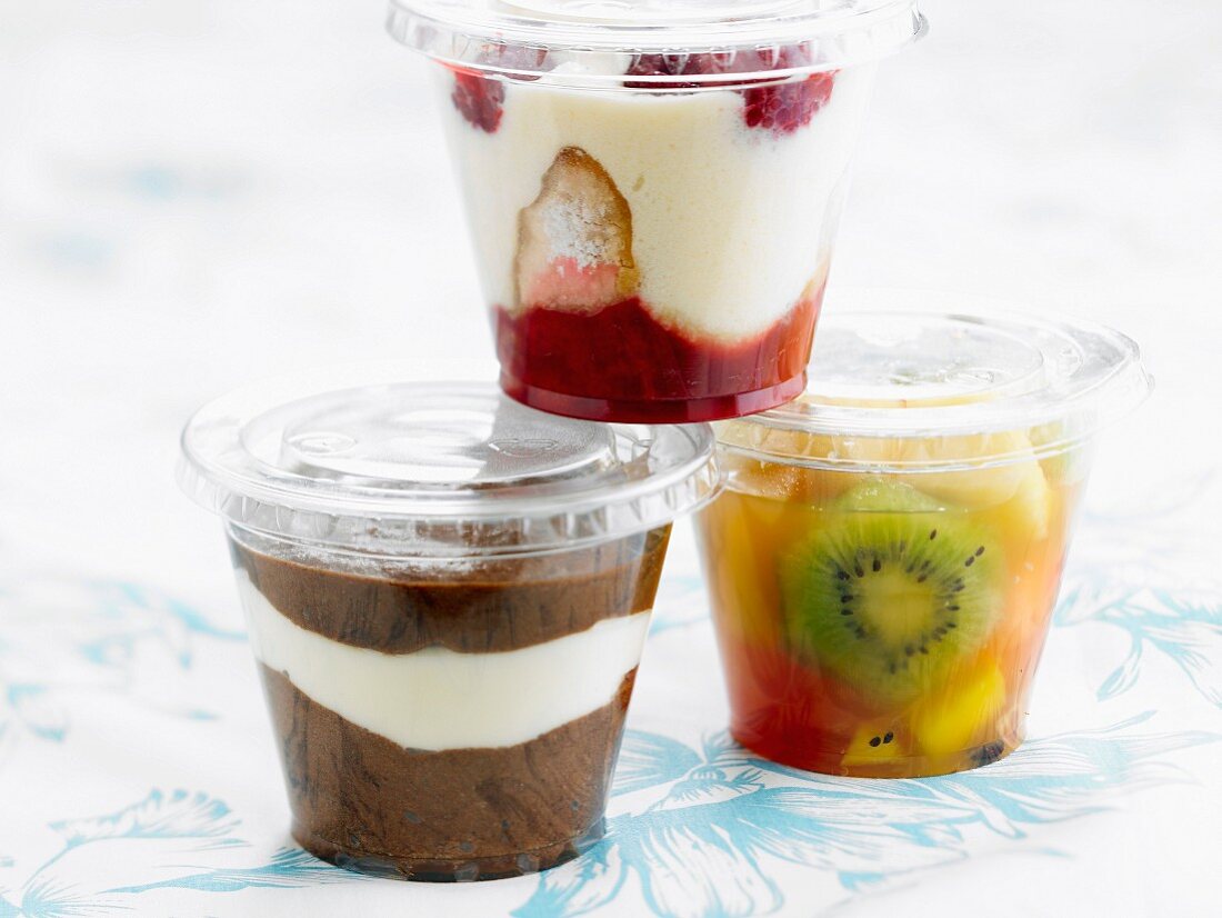 Three different desserts in take-away plastic containers