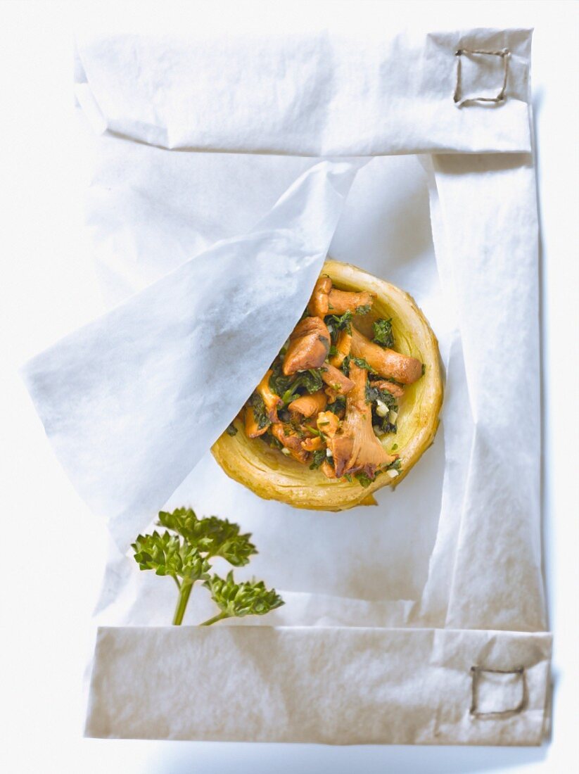 Artichoke base filled with chanterelles,minced parsley and garlic cooked in wax paper