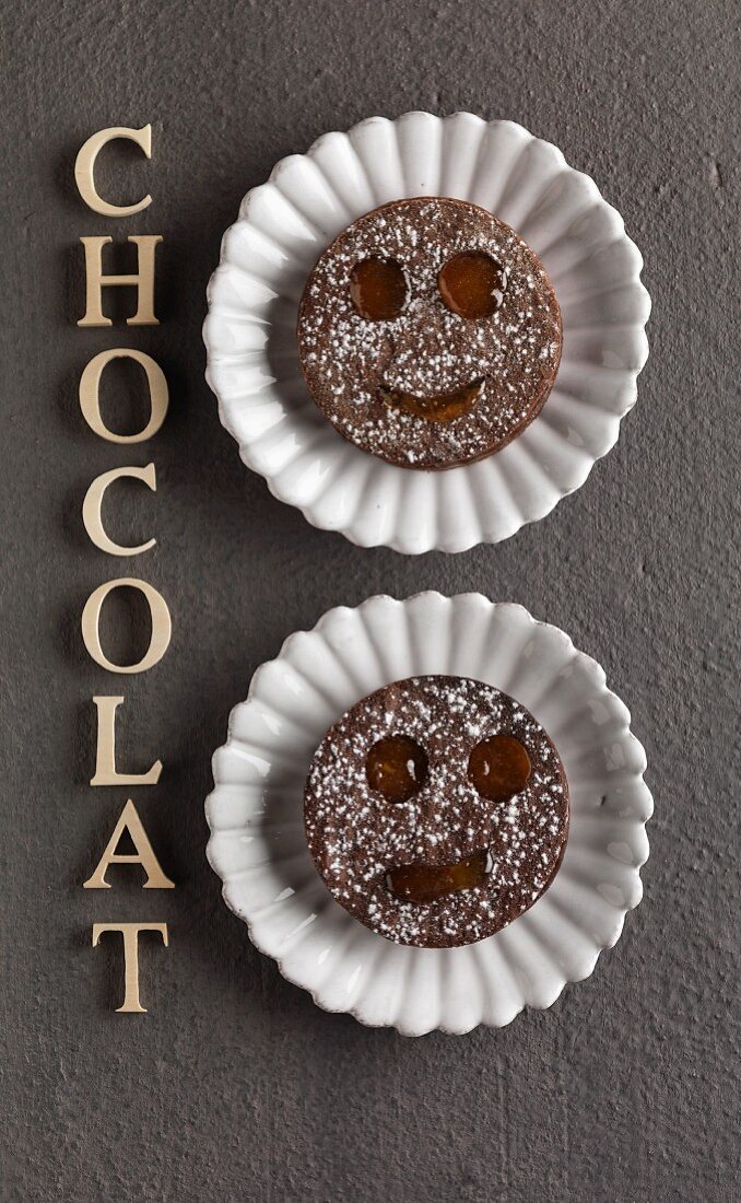 Funny faced chocolate shortbread cookies with marmelade filling
