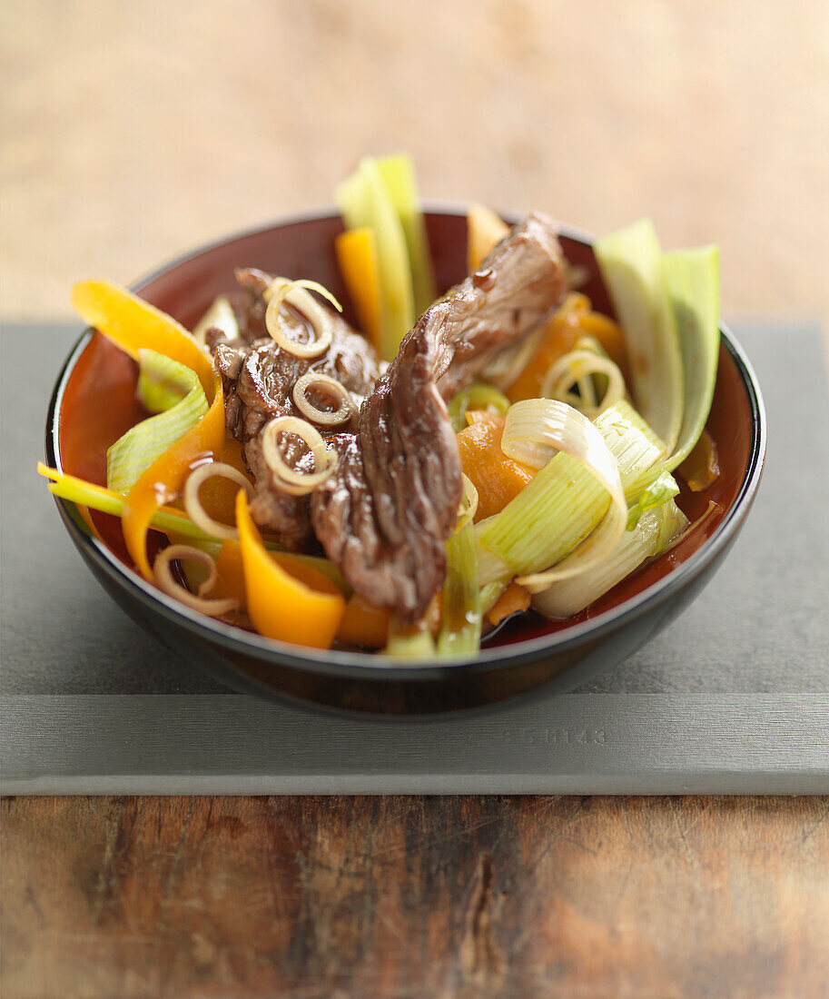 Beef and vegetables cooked in a wok