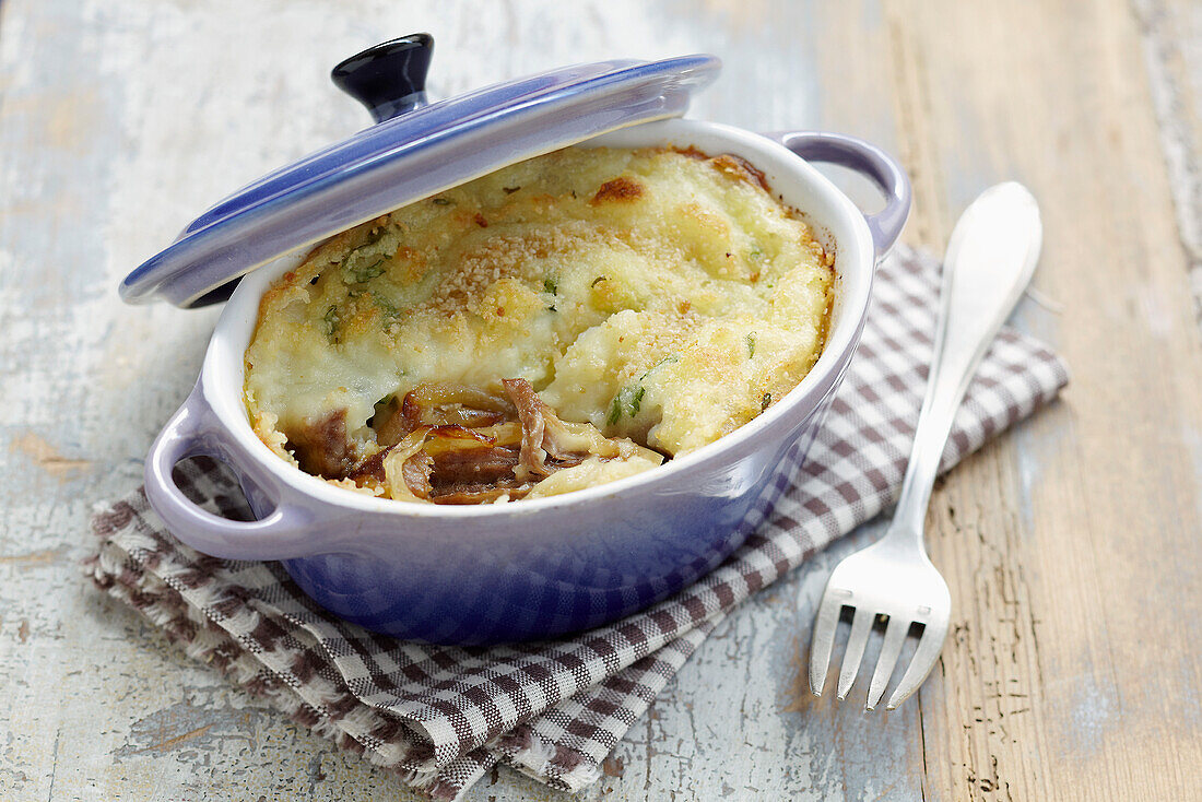 Lamb confit and coriander cheese-topped dish