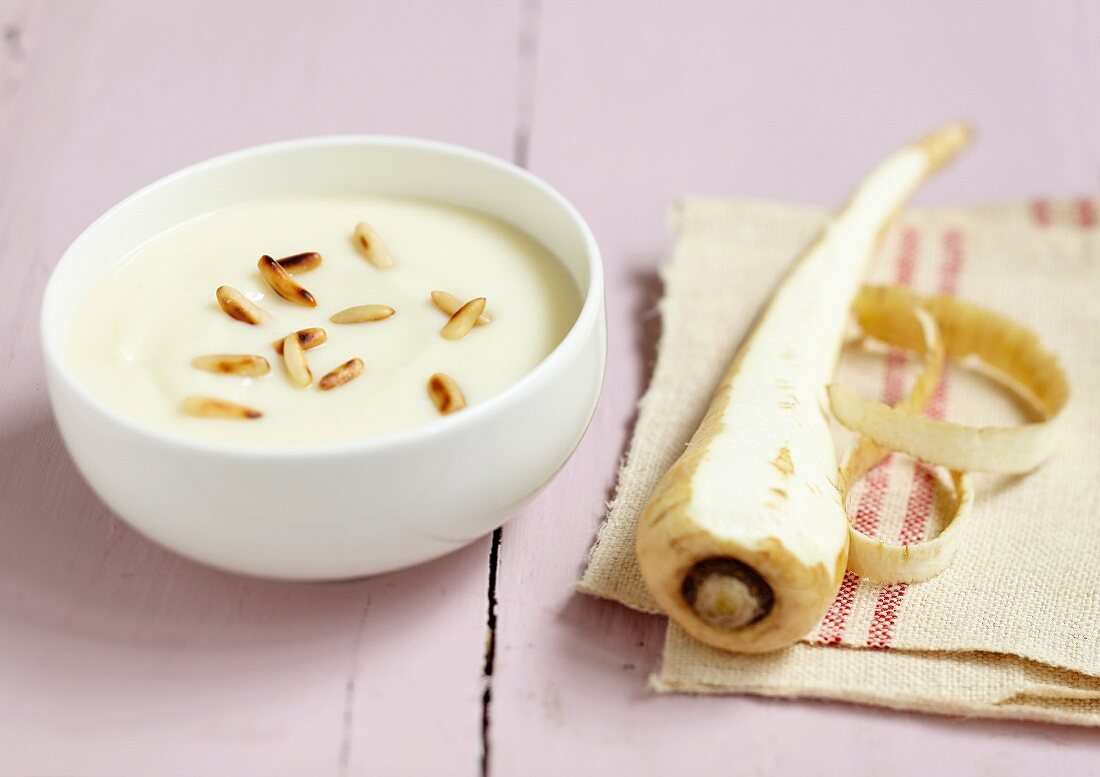 Cream of parsnip soup with grilled pine nuts