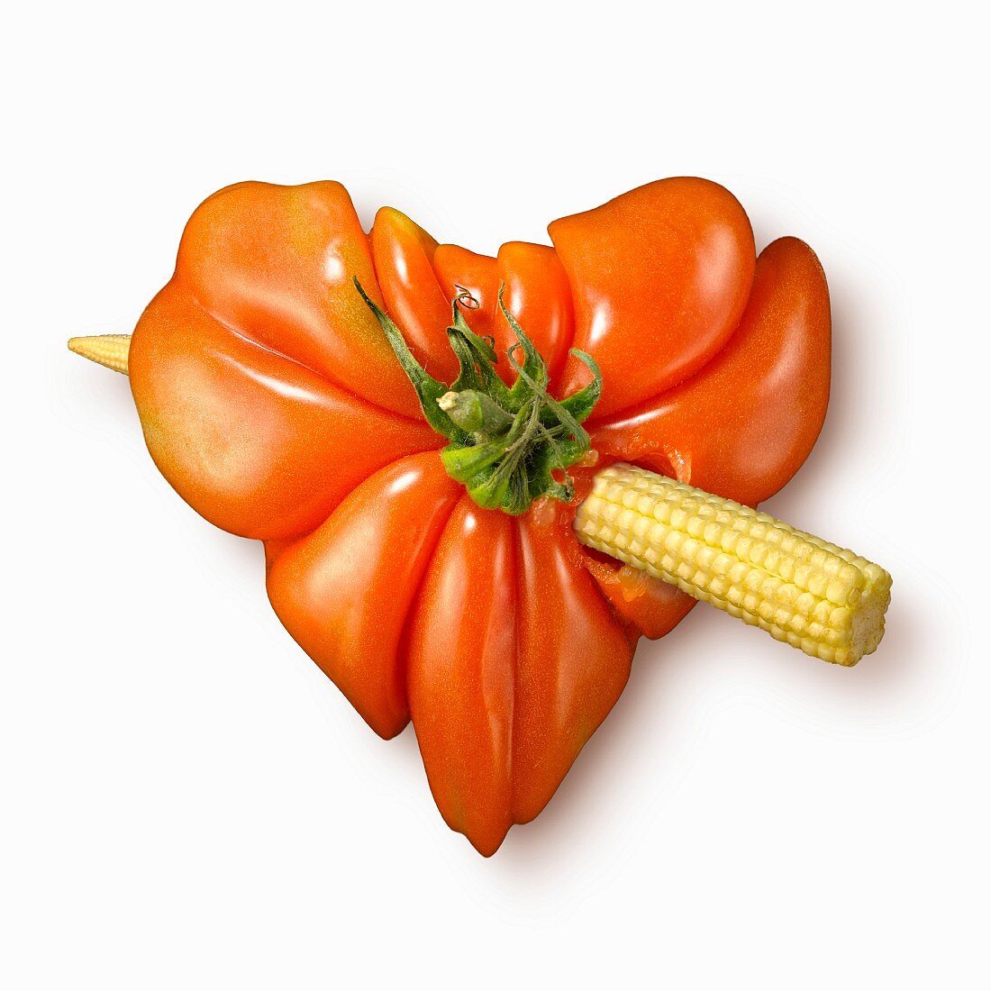 Cupid's heart made out of tomato and mini corn on the cob