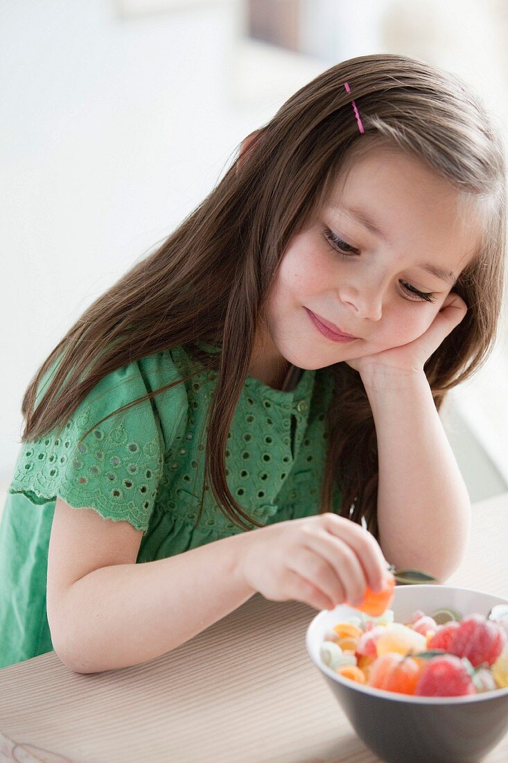 Young girl eating candies