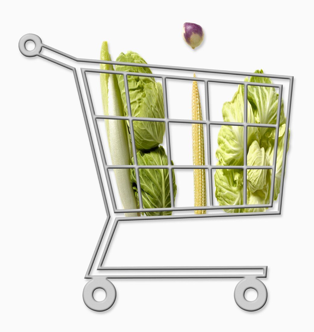 Mini supermarket trolley full of organic vegetables