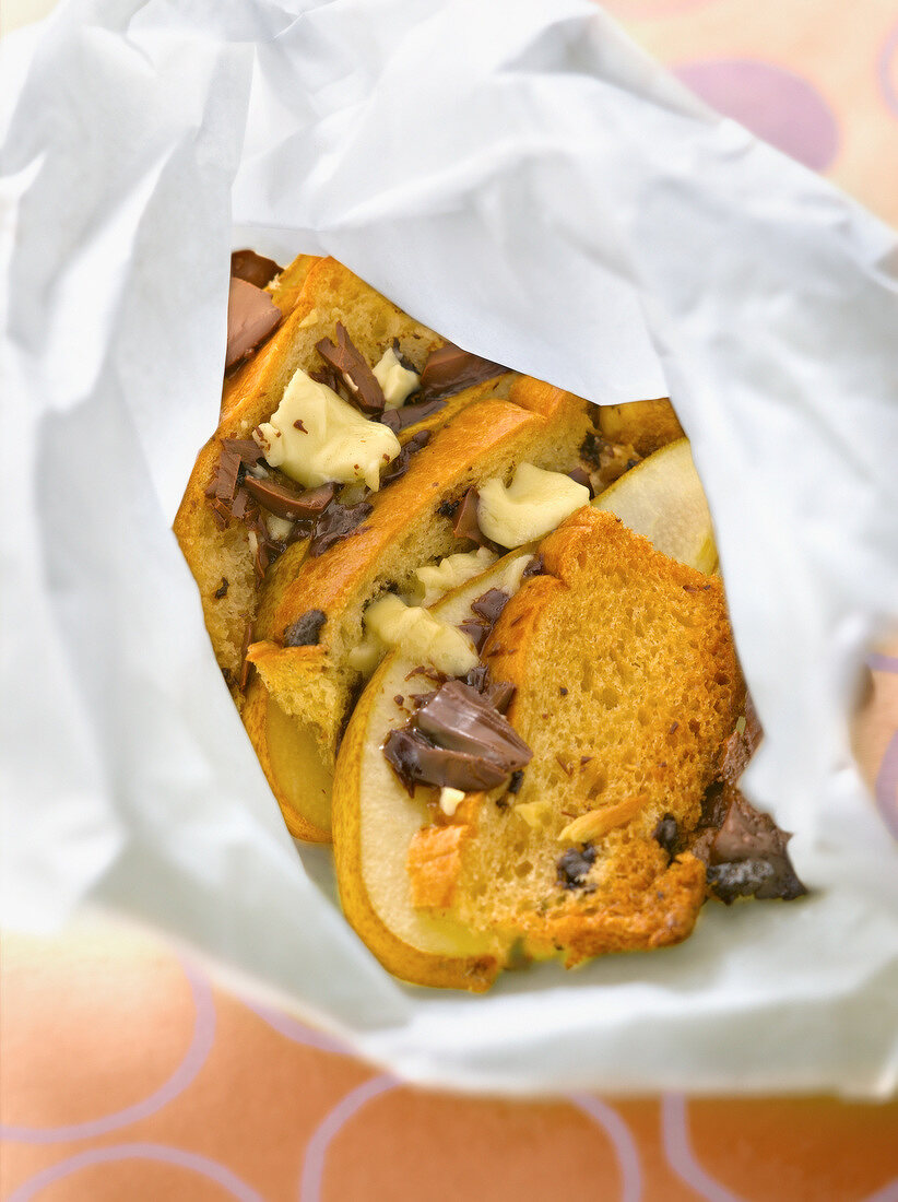 Bread, pears and two chocolates cooked in wax paper