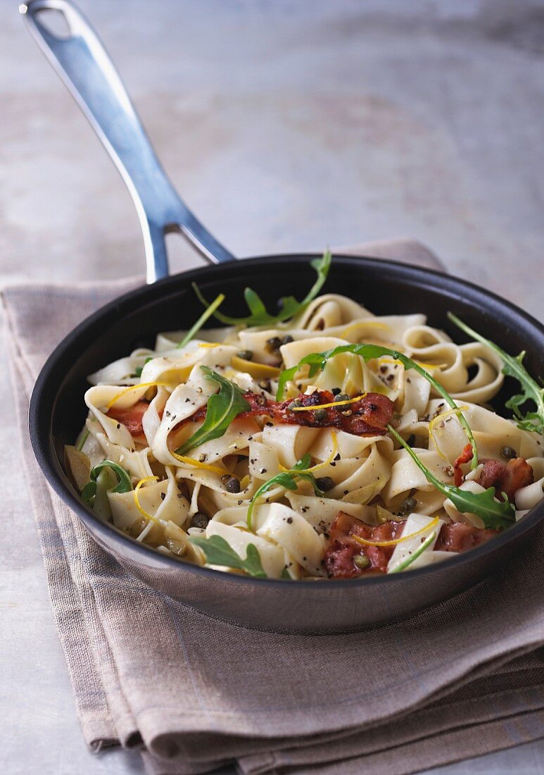 Pan-fried pasta with bacon and rocket lettuce