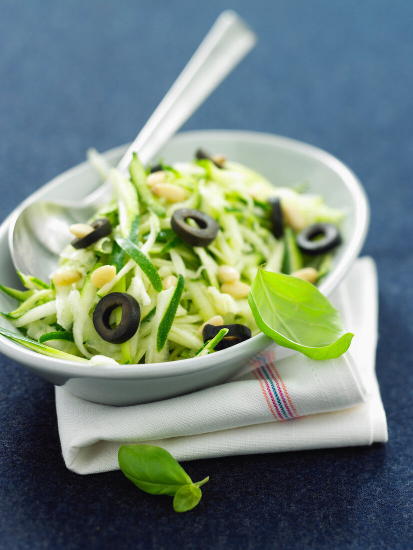 Grated zucchinis with pine nuts and olives