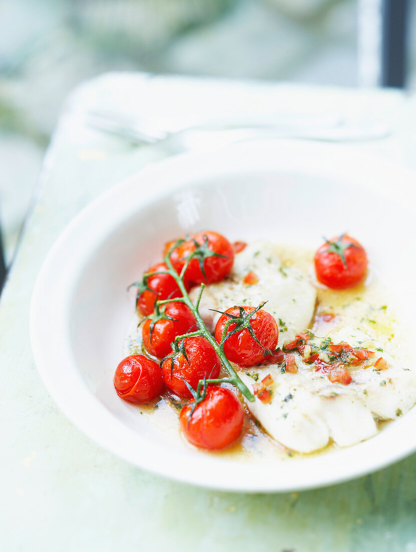 Piece of cod with Virgin sauce and grilled bunch of tomatoes