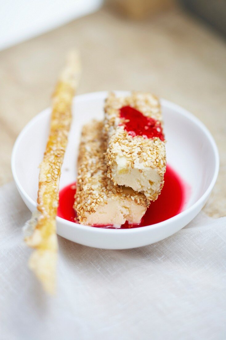 Yoghurt and sesame seed ice cream with redcurrant puree and crisp biscuit