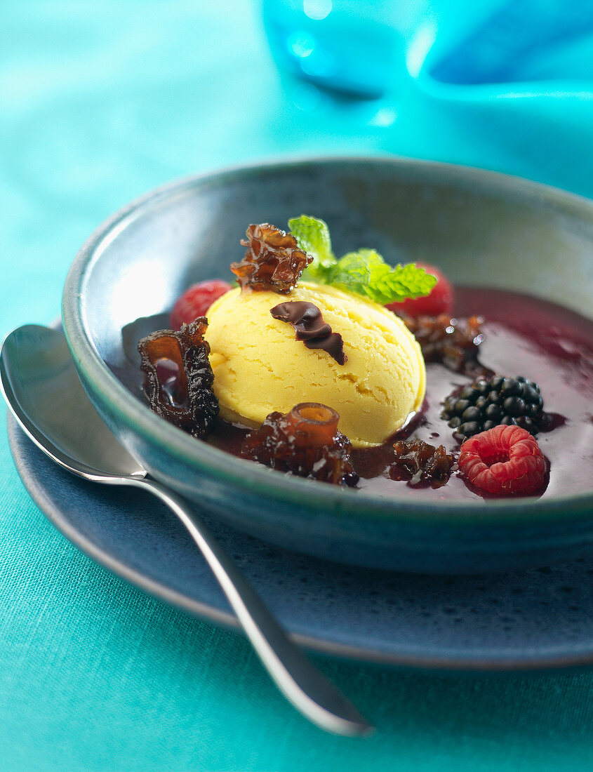 Chocolate soup with fruit and mushrooms and a scoop of ice cream