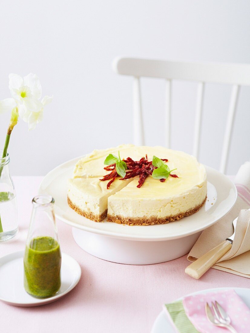 Goat's cheese cheesecake topped with sun-dried tomatoes, basil puree