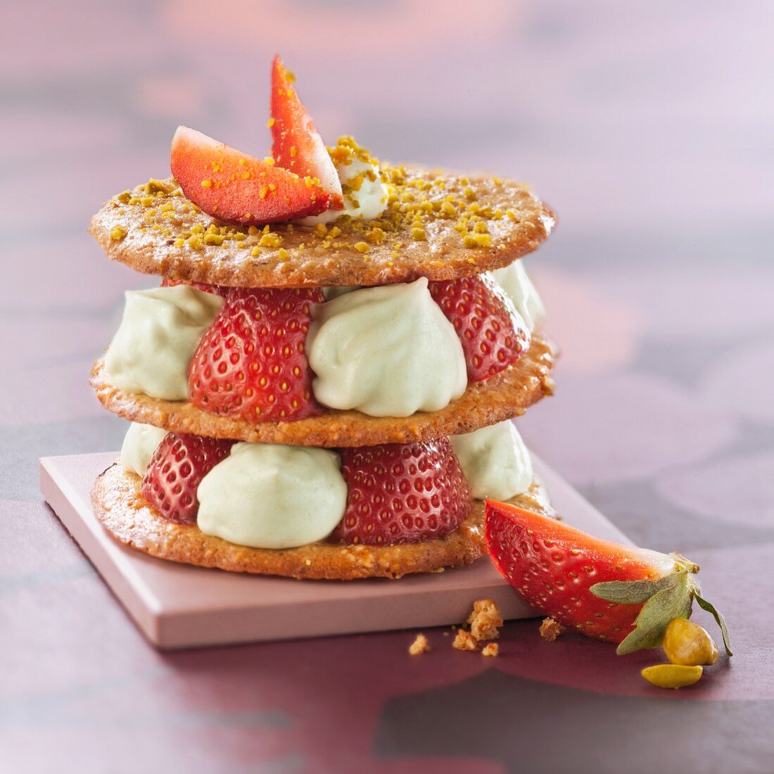 Crunchy pastry, strawberry and pistachio whipped cream dessert