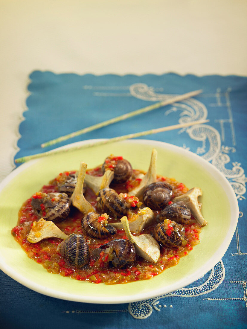 Snails with artichokes, tomato sauce with Vermouth and thinly chopped vegetables