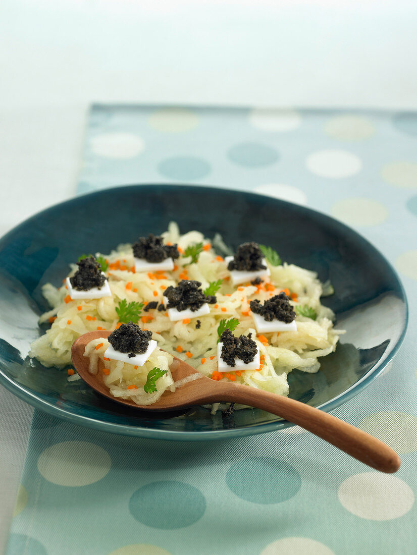 Grated apple and carrot salad with coconut milk gelatine squares topped with truffles