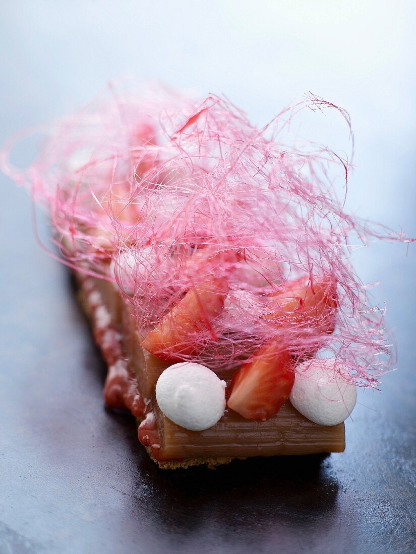Shortbread biscuit with stewed rhubarb, strawberries, meringues and cotton candy