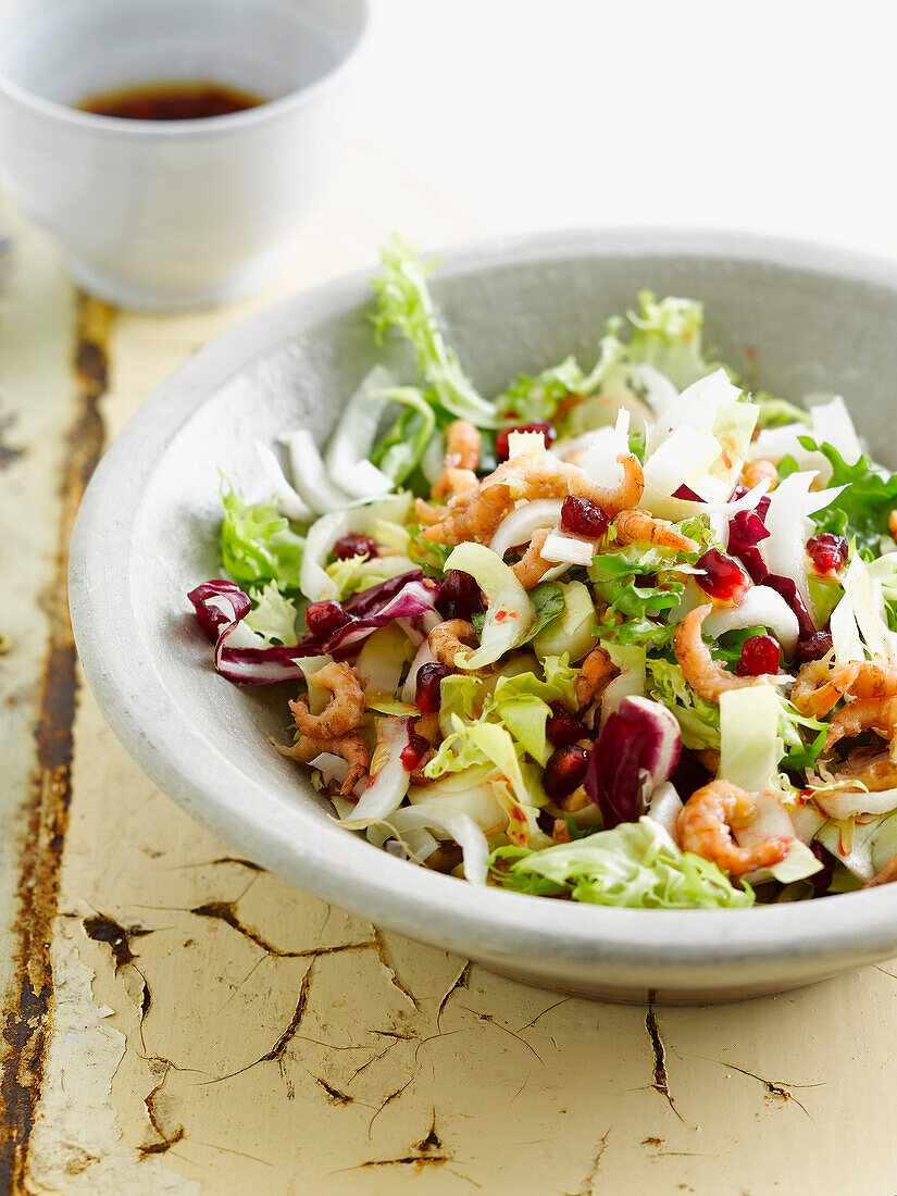 Mixed salad with shrimps and pomegranate